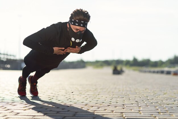 Sports man doing push ups with claps during outdoors training