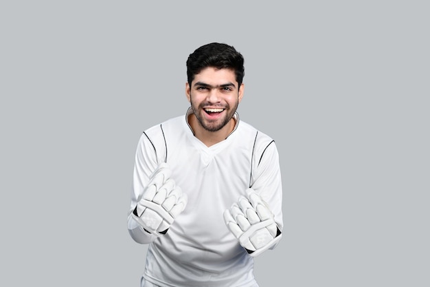 sports man smiling and wearing cricket dress indian pakistani model