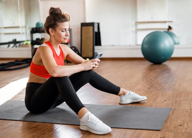 A sports person is engaged in his health A female exercise trainer does a workout at a fitness club