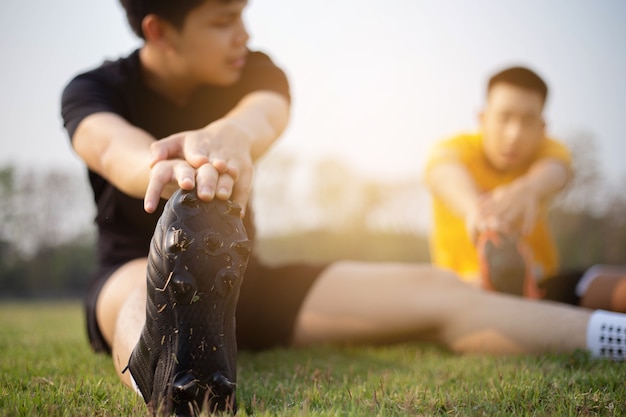 Sports and recreation concept a young male adult preparing\
himself before workout that helping reduce muscle soreness and\
lessen your risk of injury.