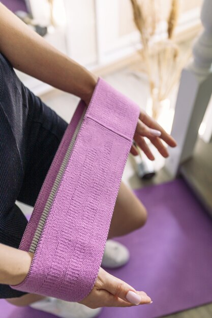 Sports and recreation concept Young woman on yoga mat taking exercise class