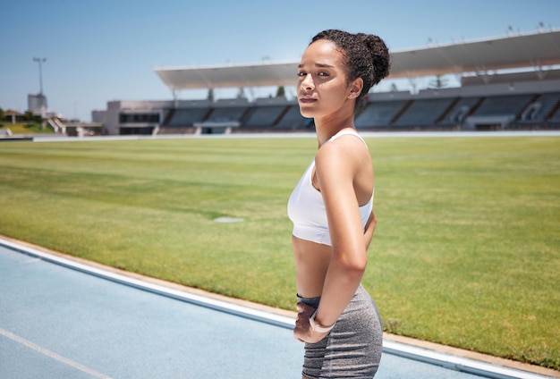 Photo sports runner and portrait of woman in stadium ready for training exercise or workout fitness health or black female athlete on outdoors race track preparing for running marathon or olympic race