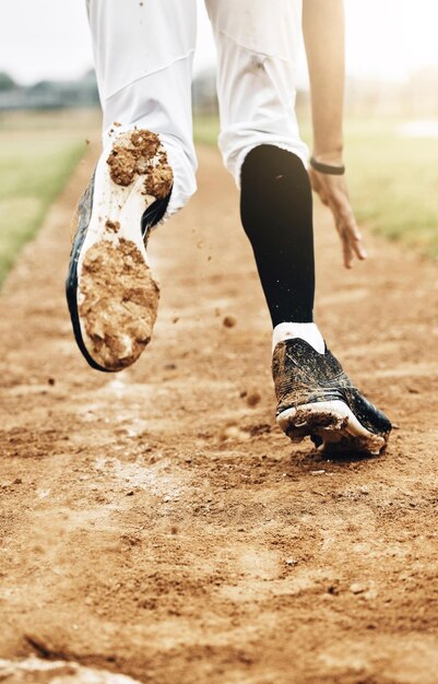 Sports running and shoes of baseball player on field training\
for competition health and fitness game workout exercise and dirt\
with athlete in competition for winning homerun or achievement