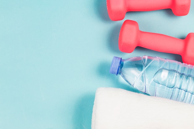 Sports shoes, dumbbell fitness in the blue background. Different sports tools