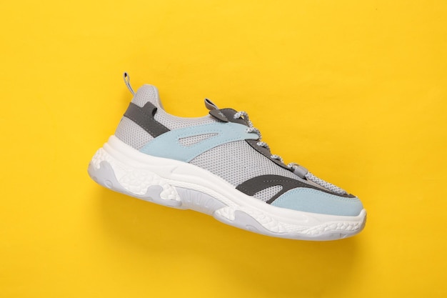 Sports sneaker on a yellow background