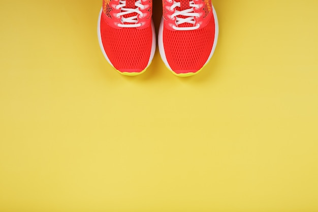 Sports sneakers, pink on a yellow with free space