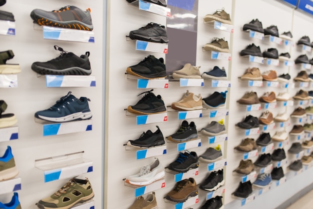 Premium Photo | Sports sneakers on a shelf in a shoe store