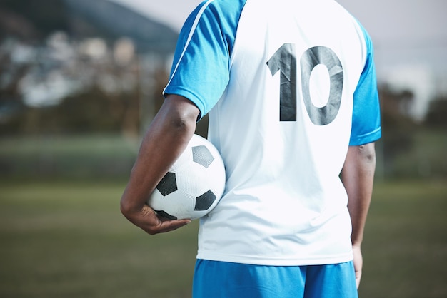 Sports soccer ball and man with uniform number on a field for exercise fitness and training outdoor Football club pitch and event or game with athlete person and mockup for sport competition