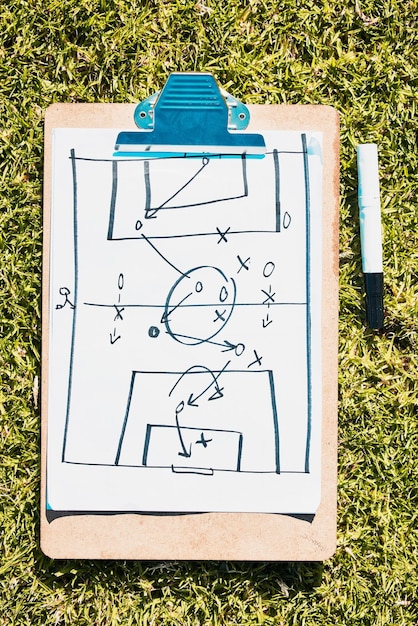 Photo sports soccer field and clipboard planning a strategy for a group mission target or tactics for goals solutions teamwork and coach drawing winning tactics or ideas on grass in a football stadium