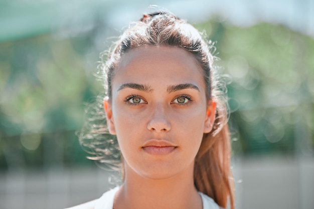 Sports winner mindset and a portrait woman on outdoor tennis or badminton court before practice game Health fitness workout and beauty headshot of girl with beautiful face and winning motivation