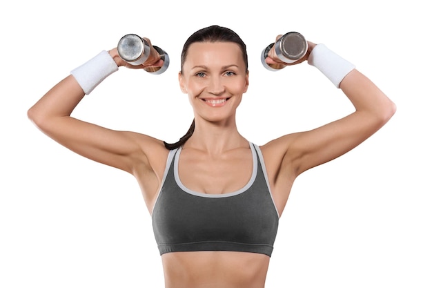 A sports woman with dumbbells looking at camera smiling isolated