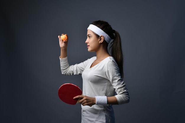 Sports women holding table tennis ball indian pakistani
model