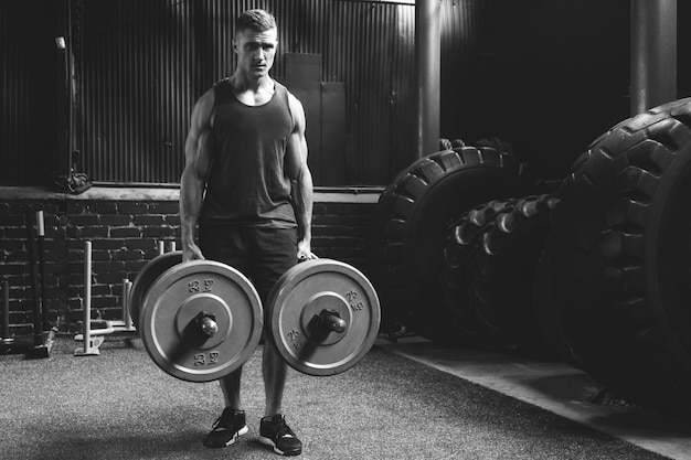 Sportsman doing farmer's walk exercise during his cross training workout