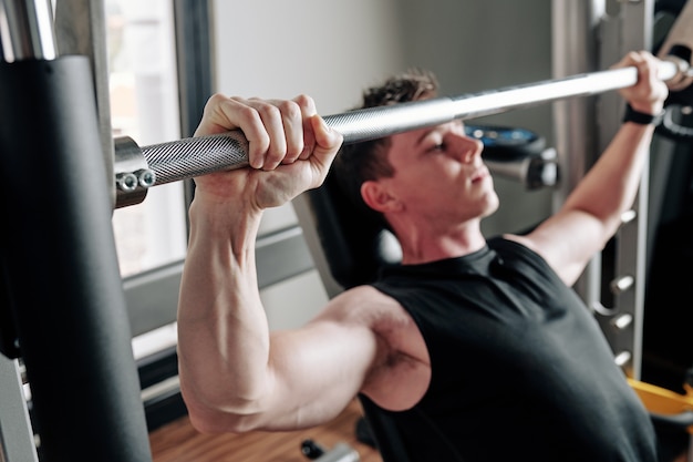 Sportsman lifting heavy barbell