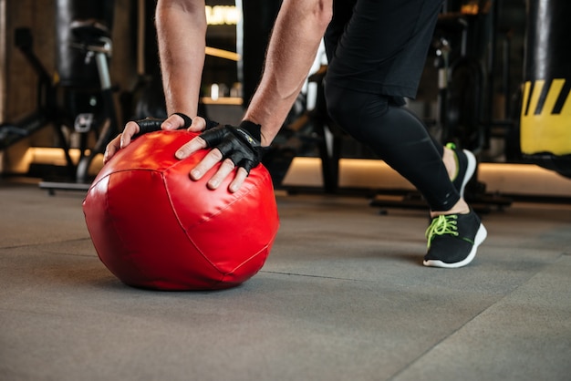 Sportsman make sport exercises in gym