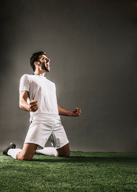 Sportsman shouting while rejoicing over victory