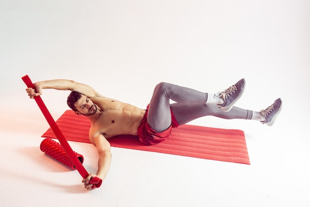 Sportsman train abdominal muscles on fitness mat