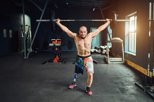 Sportsman with prosthesis working out in gym