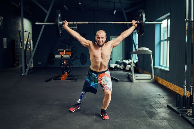 Sportsman with prosthesis working out in gym