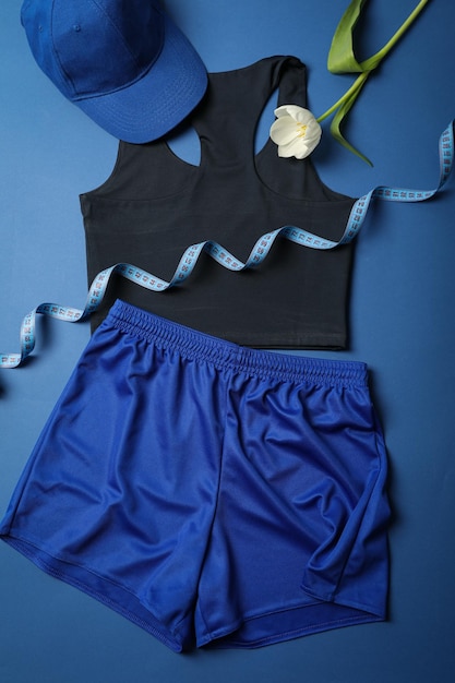Photo sportswear and accessories with flowers on a blue background