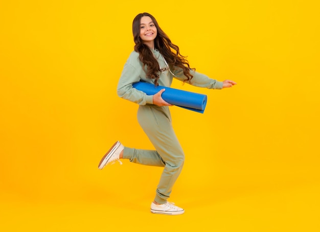 Sportswear advertising concept teenager child girl in\
tracksuits jogging suit posing in the studio