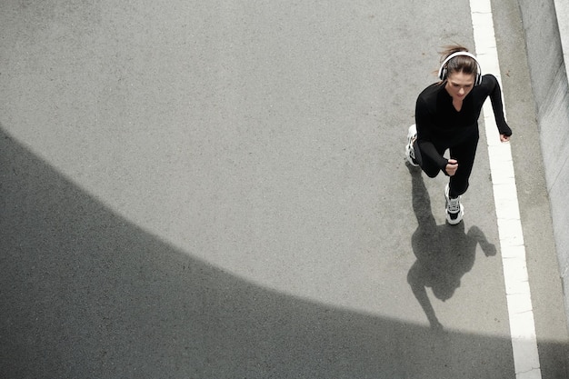 Sportswoman Jogging on Road