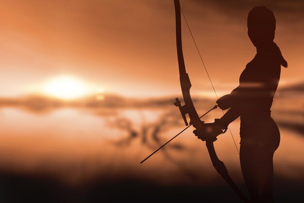 Sportswoman practicing archery against beautiful african scene