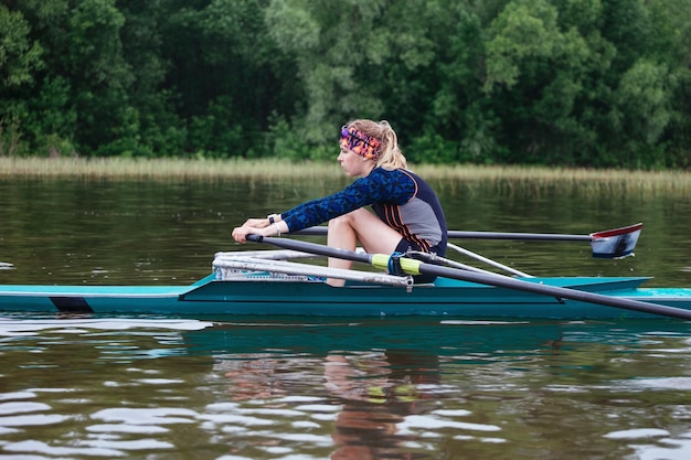 The sportwoman girl is kayaking training work hard on the river