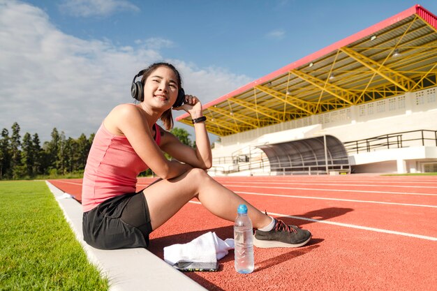 Sporty asian woman runner in fashionable sportswear