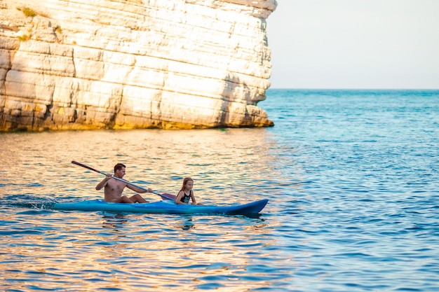 Sporty attractive family kayaking on sea together