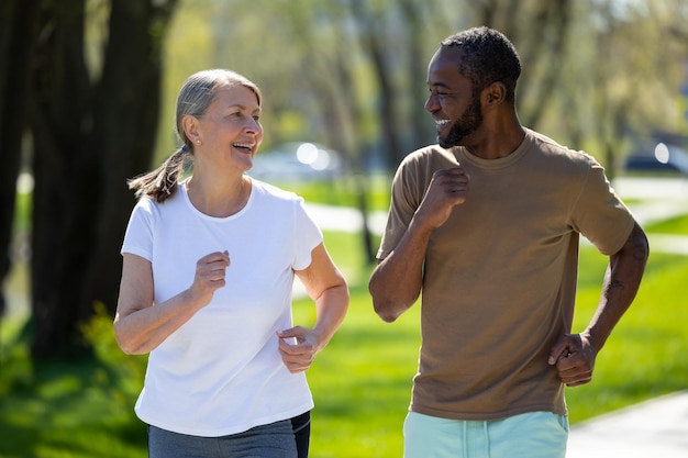 Sporty couple Happy couple jogging together in the park and looking exciting