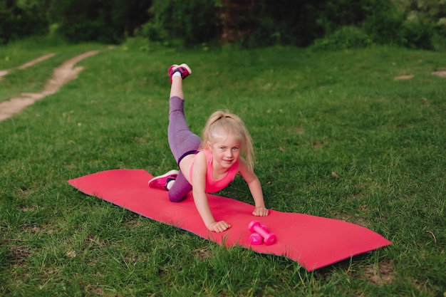 A sporty girl does gymnastic exercises on a mata healthy\
lifestyle