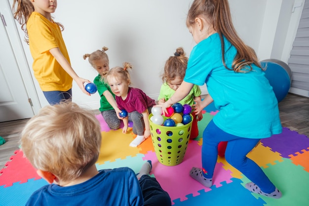 Sporty kids enjoying activities with young teacher