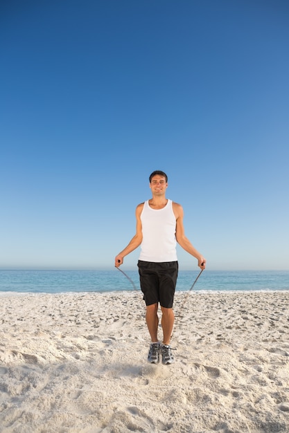 Sporty man jumping rope