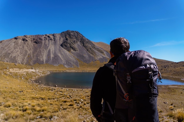 Sporty man with backpack on the rock