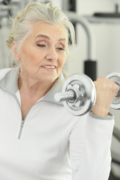 Sporty senior woman training in gym