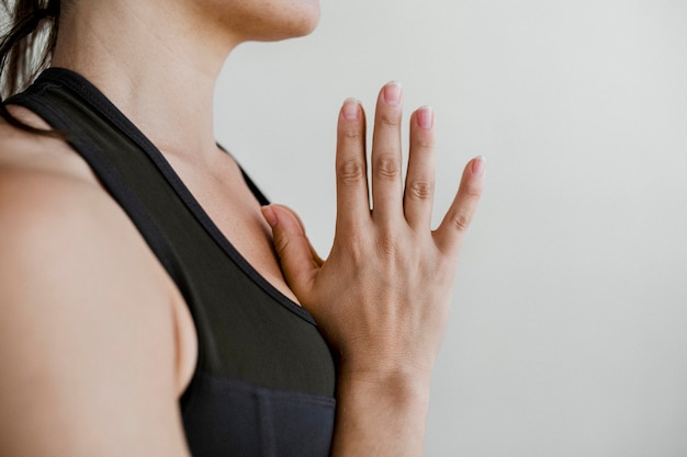 sporty woman in anjali mudra pose