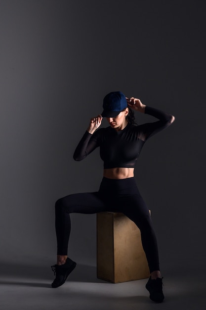 sporty woman in dark scene