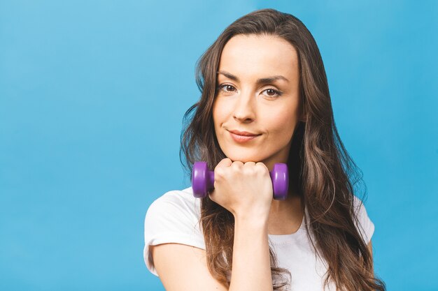 Sporty woman doing exercises with dumbbells