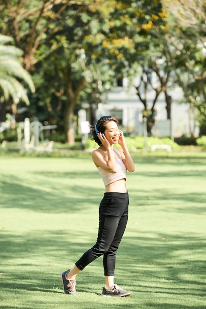 Sporty woman enjoying music