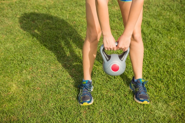 Sporty woman exercising with kettlebell 