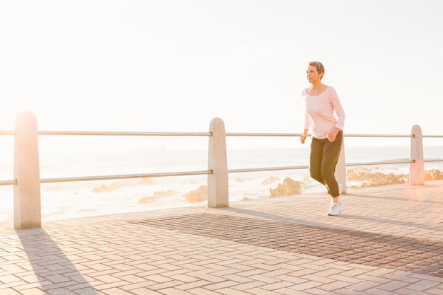 Sporty woman jogging at promenade