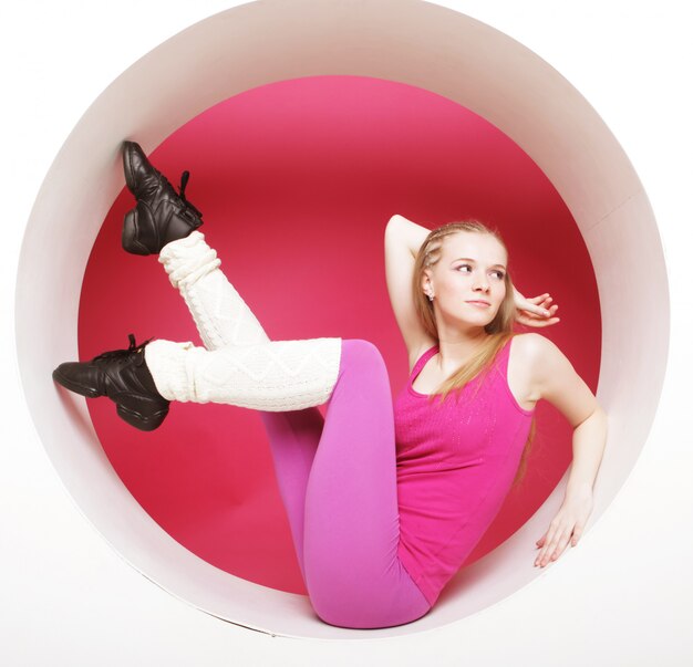 Sporty woman posing in pink circle