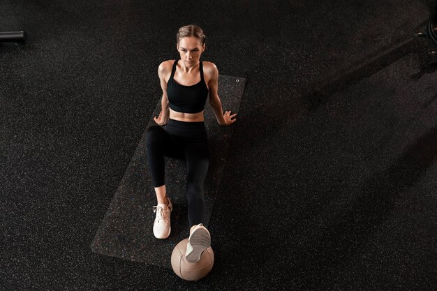 Sporty woman resting having break after doing exercise Top view