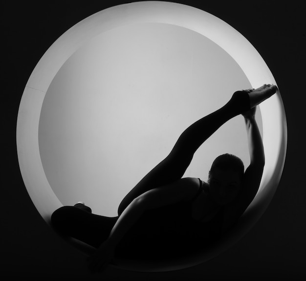 Sporty woman stretching inside a circle 