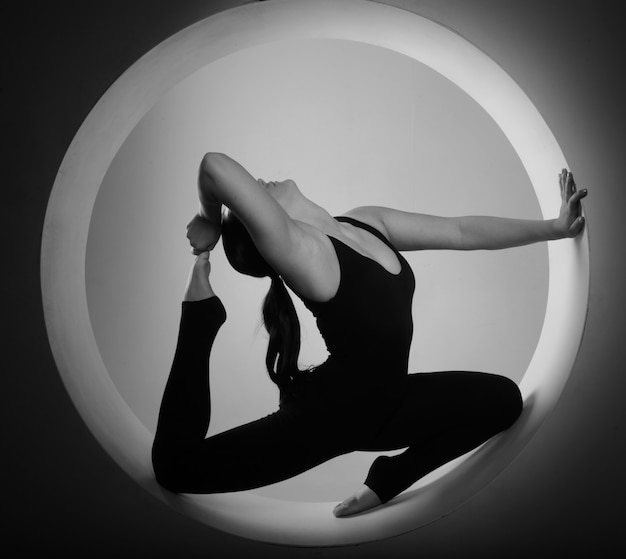 Sporty woman stretching inside a circle 