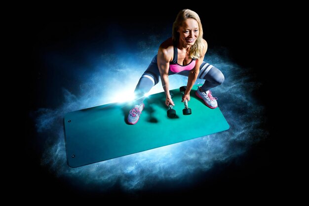 Sporty woman with beautiful beautiful body working out on black background