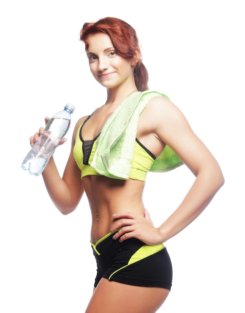 Sporty woman with mineral water over white