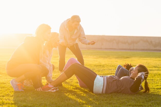 Sporty women doing sit ups during fitness class