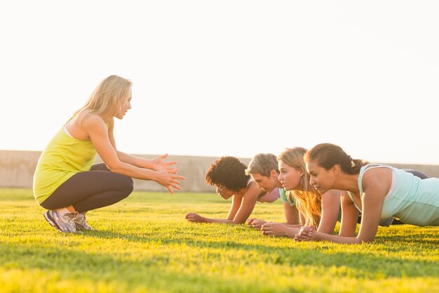 Sporty women planking during fitness class